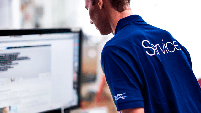 man standing next to a computer