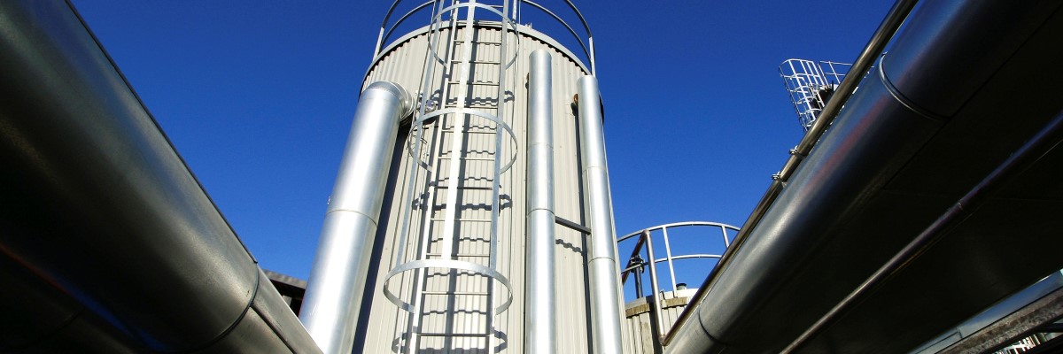 Petrochemical plant tower in front of a blue sky