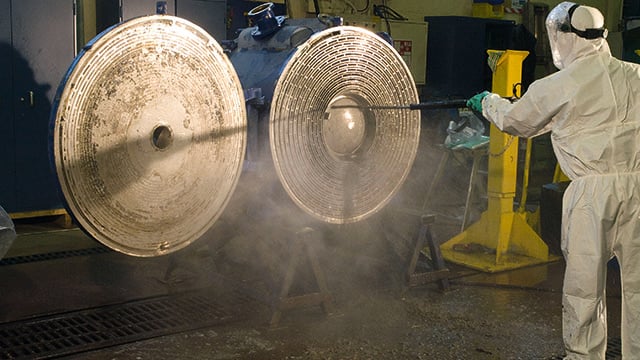 Man cleaning Alfa Laval welded spiral heat exchangers
